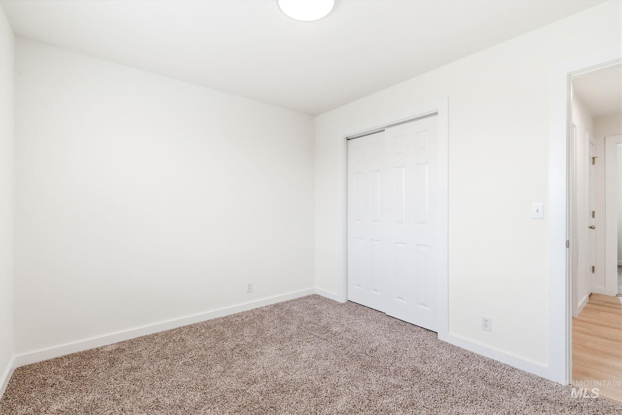 696 West Rams Hill Street Kuna, ID 83634 - Photo 36 of 46 Unfurnished bedroom with carpet flooring and a closet