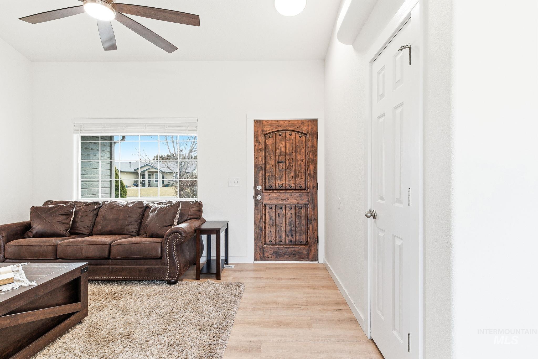 696 West Rams Hill Street Kuna, ID 83634 - Photo 4 of 46 Living area with light wood-type flooring and ceiling fan