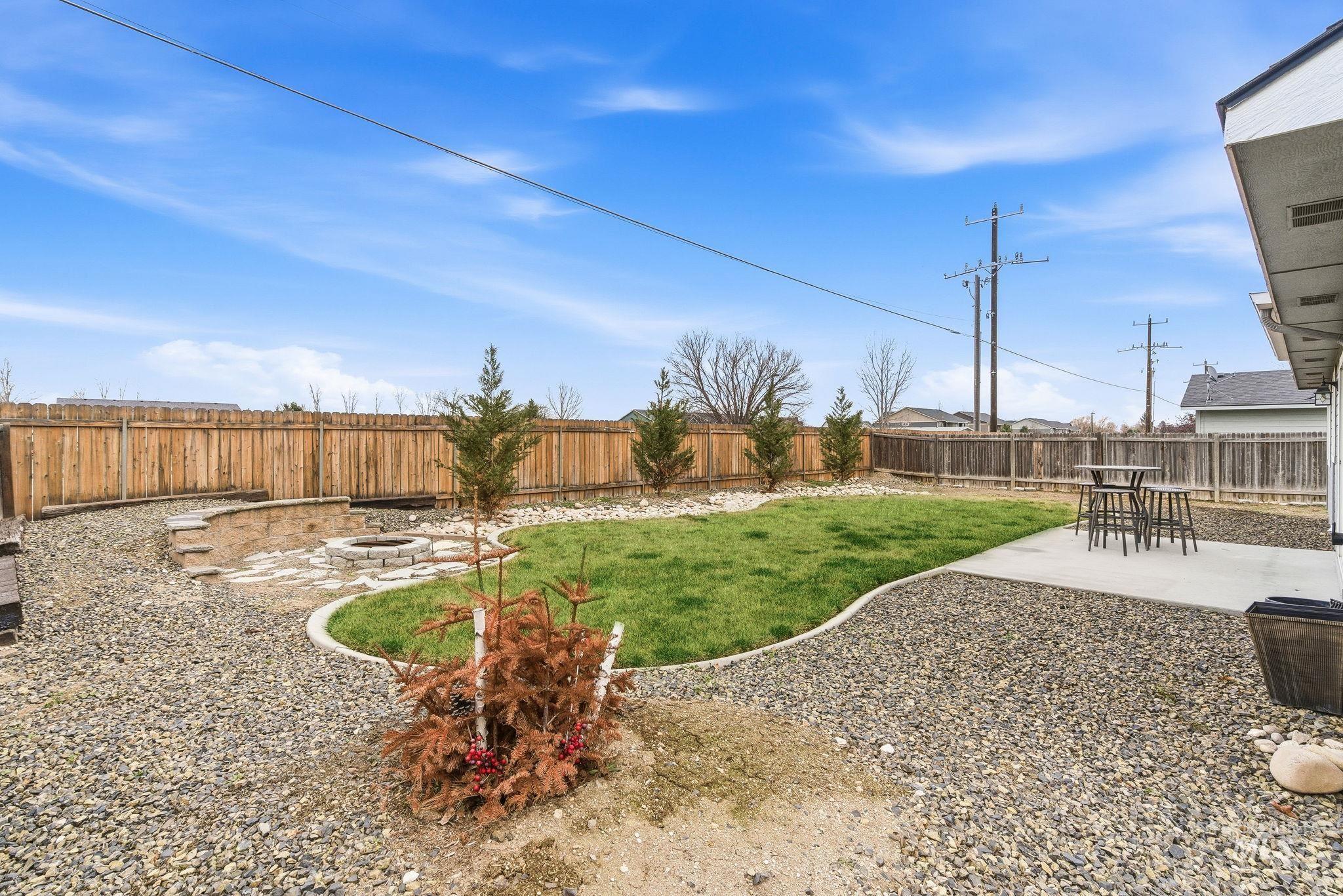 696 West Rams Hill Street Kuna, ID 83634 - Photo 41 of 46 Fenced backyard with a patio area and a fire pit