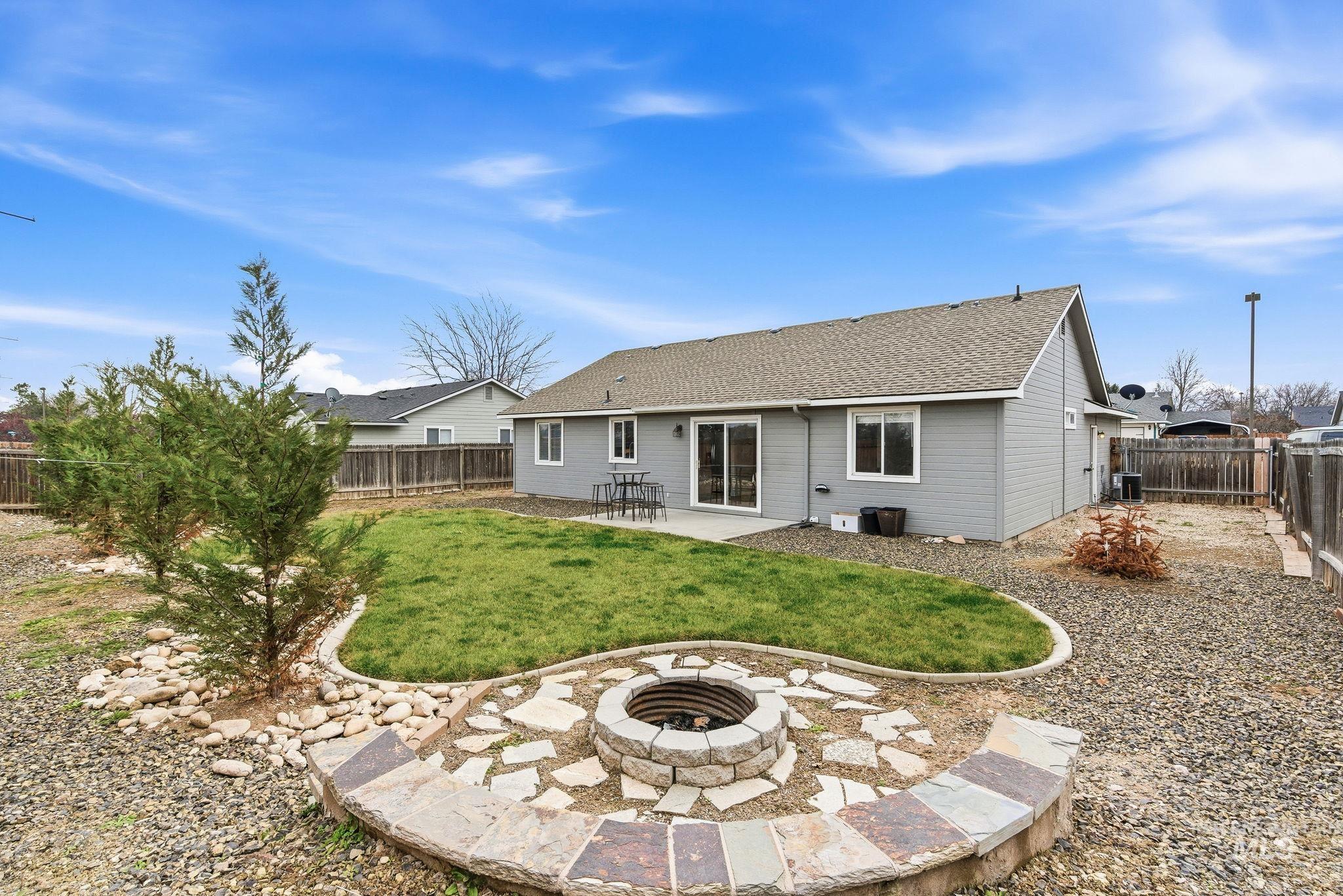 696 West Rams Hill Street Kuna, ID 83634 - Photo 42 of 46 Rear view of house with a patio, a shingled roof, and a fenced backyard