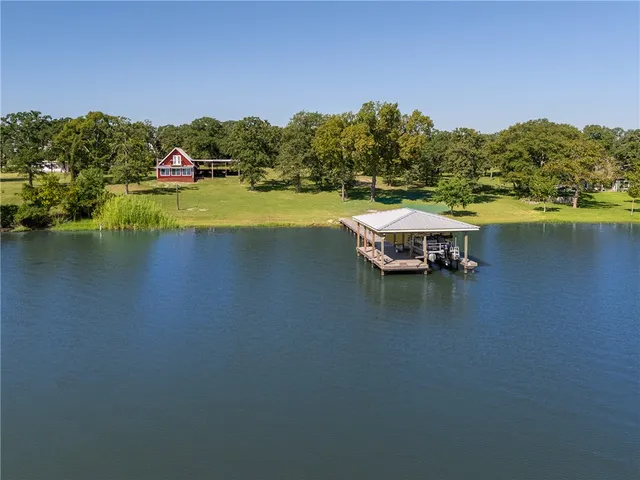 a view of a lake with houses in the back