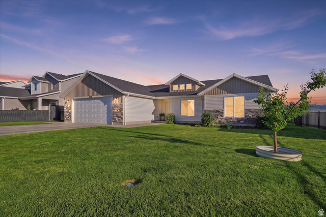 1422 West 3410th Street South Logan, UT 84321 - Photo 2 of 33 Single-story residence featuring a two-car garage, stone and siding exterior, and a dormer window detail