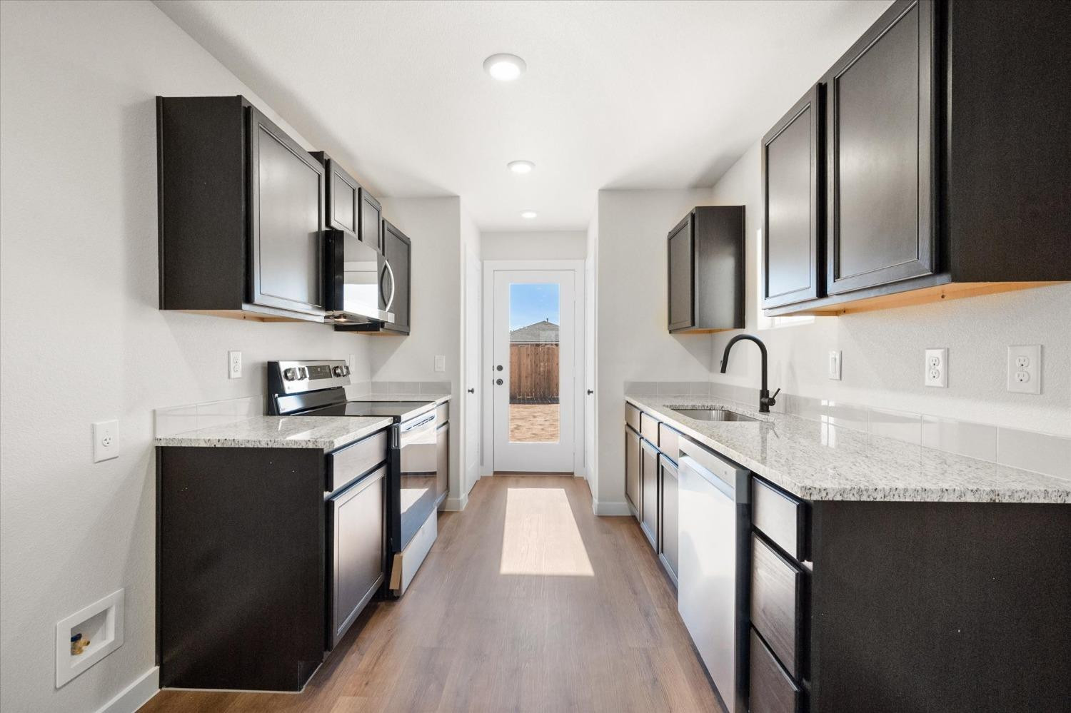 5519 Queens Street Lubbock, TX 79416 - Photo 11 of 21 a large kitchen with a sink and cabinets