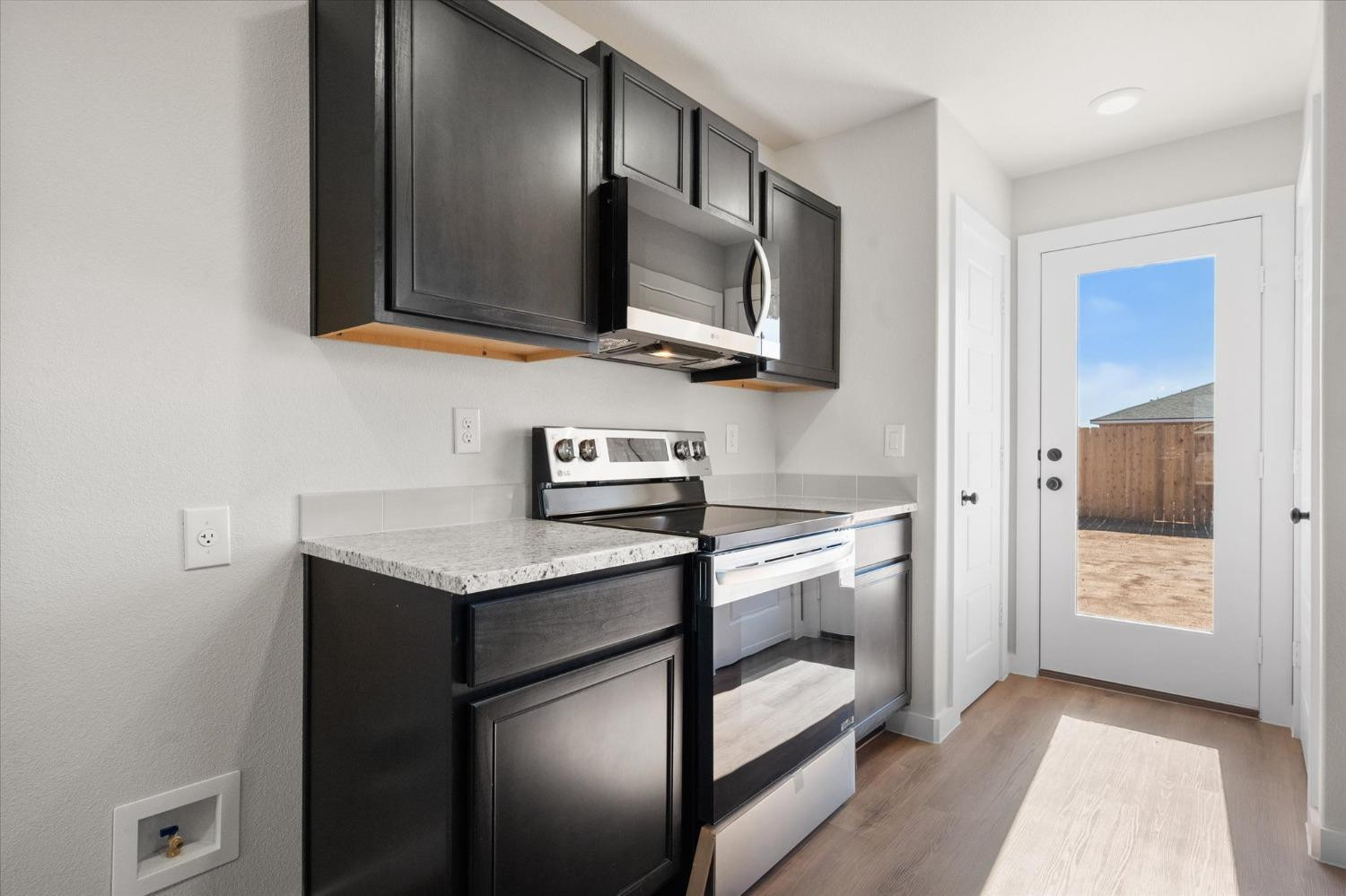 5519 Queens Street Lubbock, TX 79416 - Photo 13 of 21 a kitchen with stainless steel appliances granite countertop a refrigerator and a stove top oven