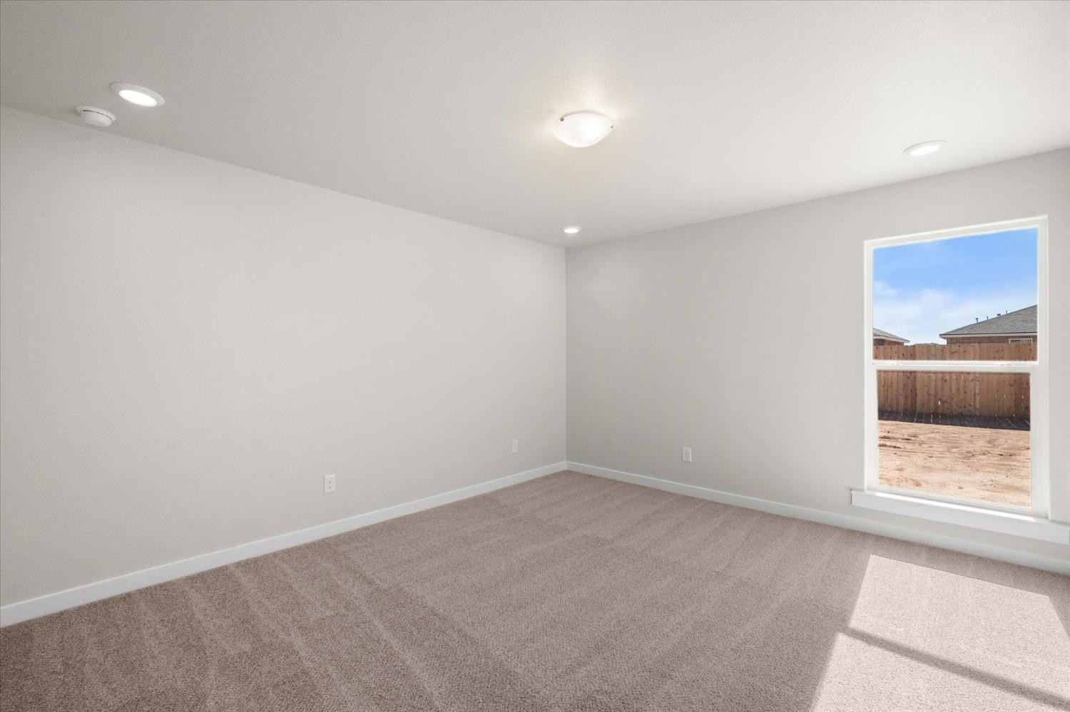 5519 Queens Street Lubbock, TX 79416 - Photo 15 of 21 wooden floor in an empty room with a window