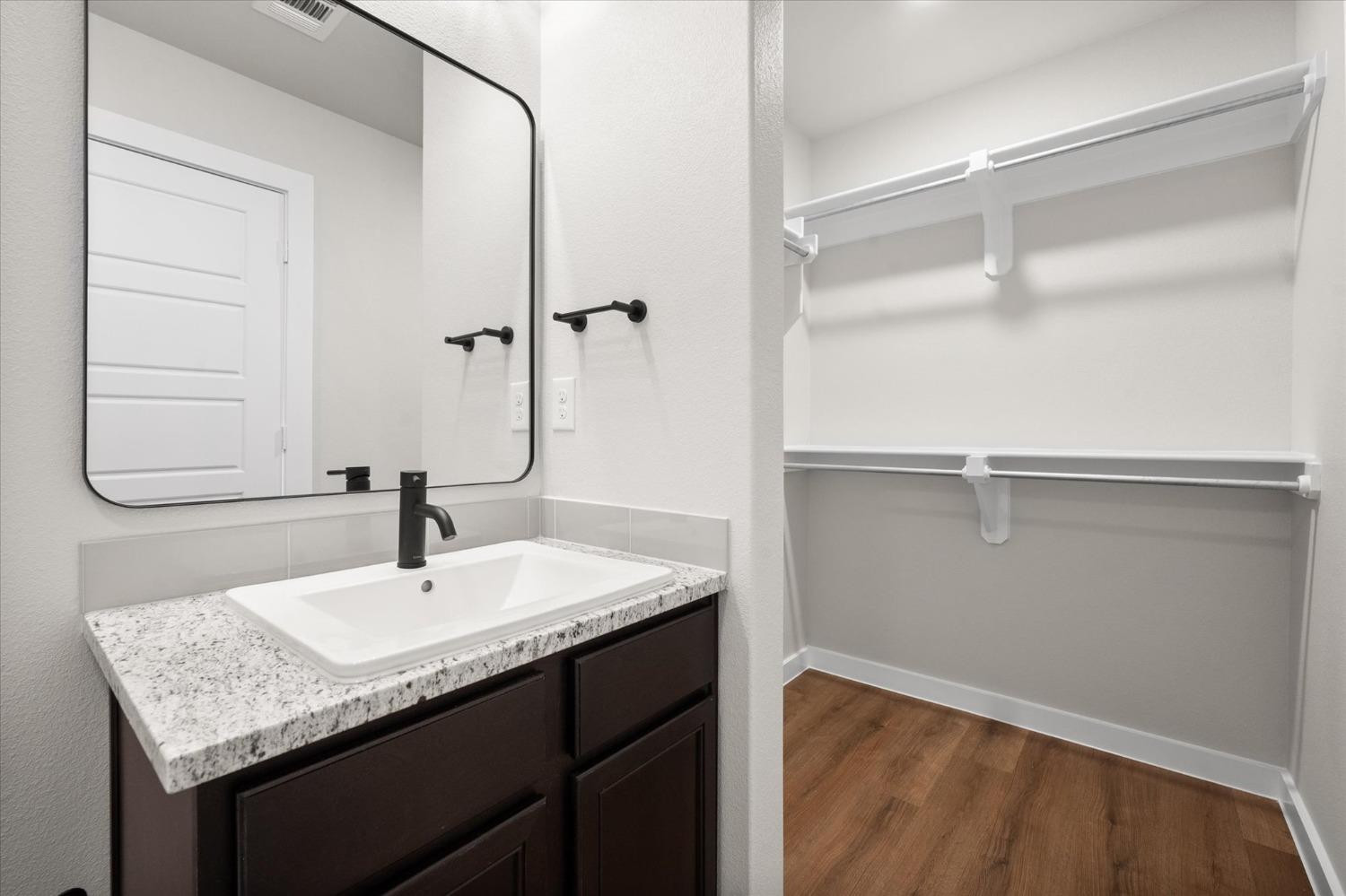 5519 Queens Street Lubbock, TX 79416 - Photo 18 of 21 a bathroom with a granite countertop sink and a mirror