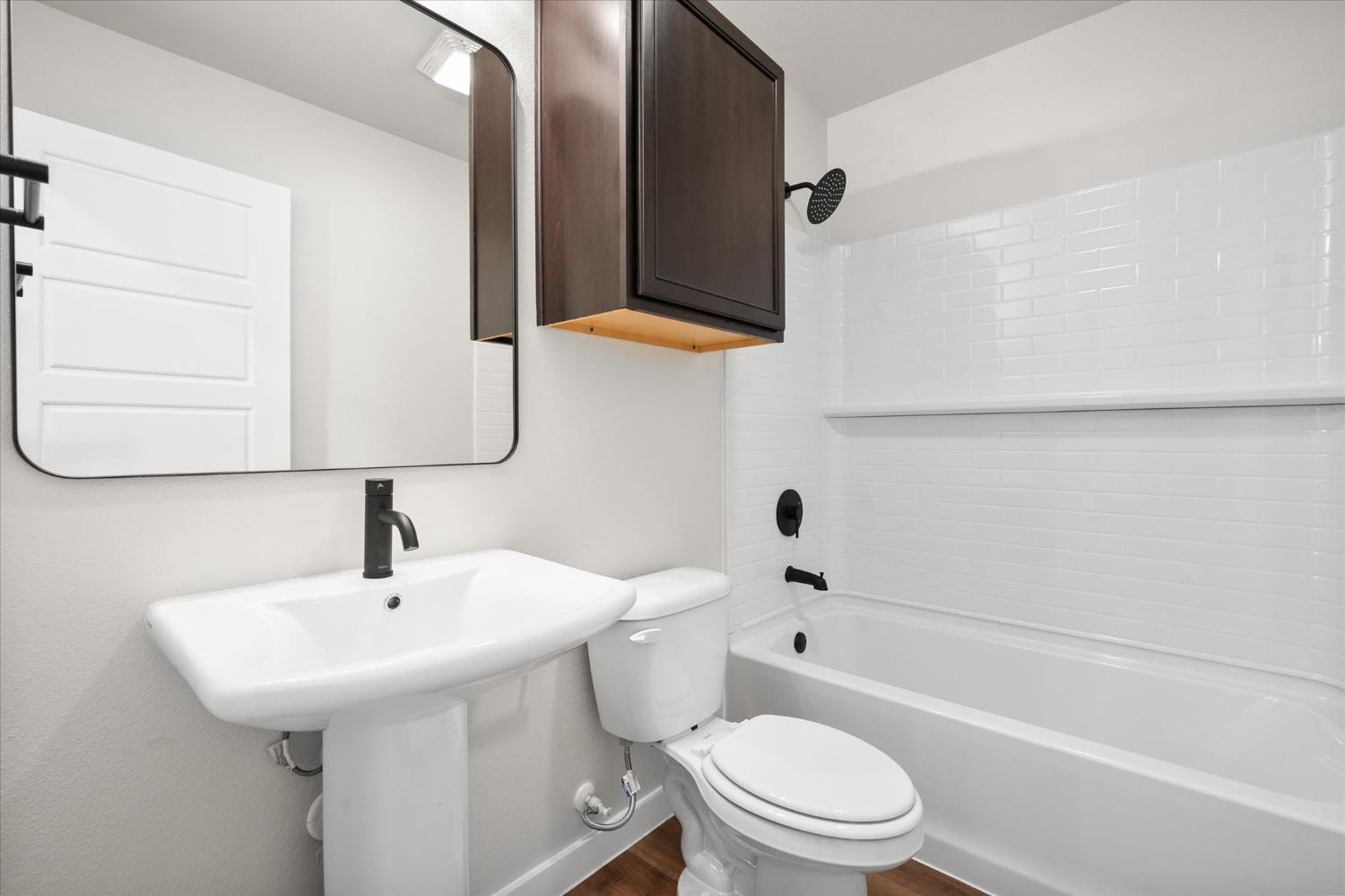 5519 Queens Street Lubbock, TX 79416 - Photo 9 of 21 a bathroom with a sink a toilet and bathtub
