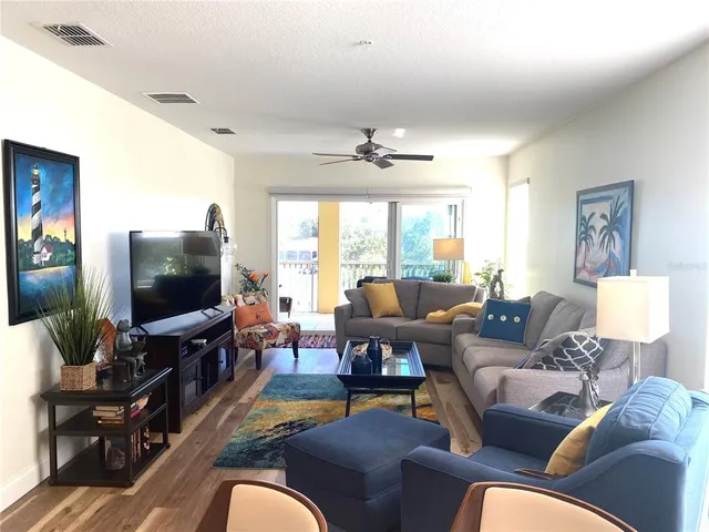 a view of a livingroom with furniture and a porch