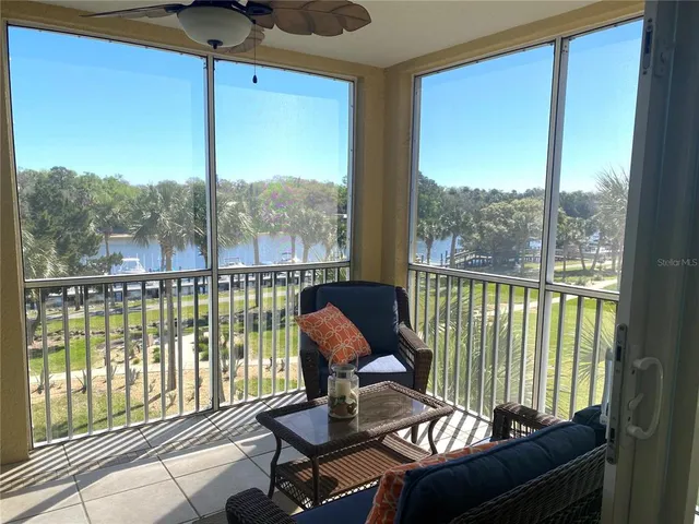 a kitchen with cabinets a sink and chairs