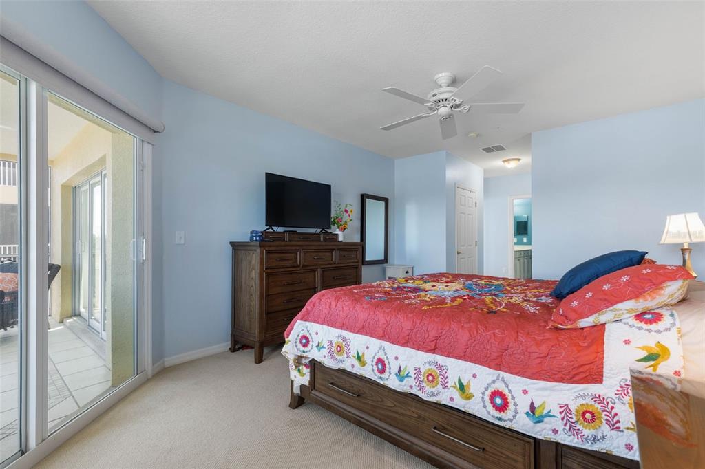 700 Canopy Walk Lane, Unit 735 Palm Coast, FL 32137 - Photo 32 of 77 a bedroom with a bed and a flat tv screen on dresser