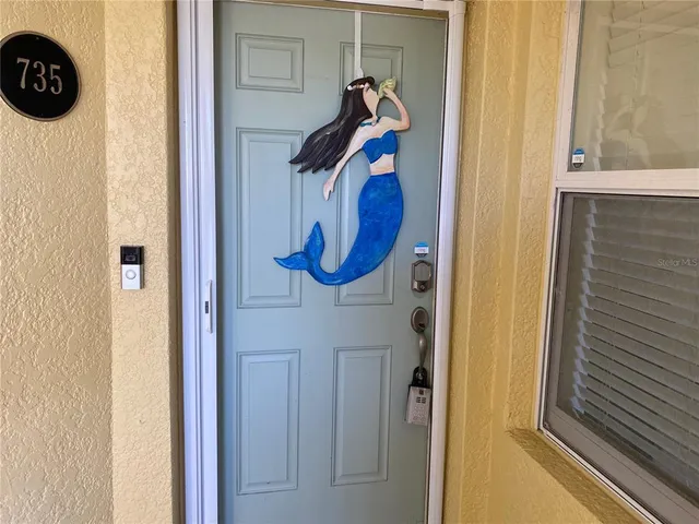 a living room with lots of furniture and a painting on the wall