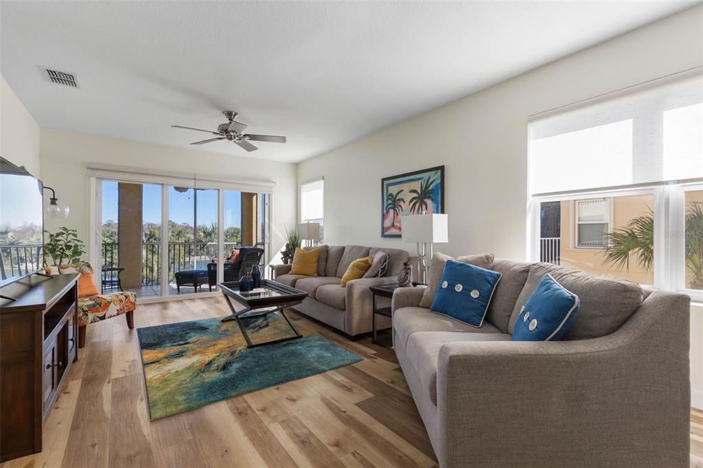 700 Canopy Walk Lane, Unit 735 Palm Coast, FL 32137 - Photo 10 of 77 a living room with furniture large window and wooden floor
