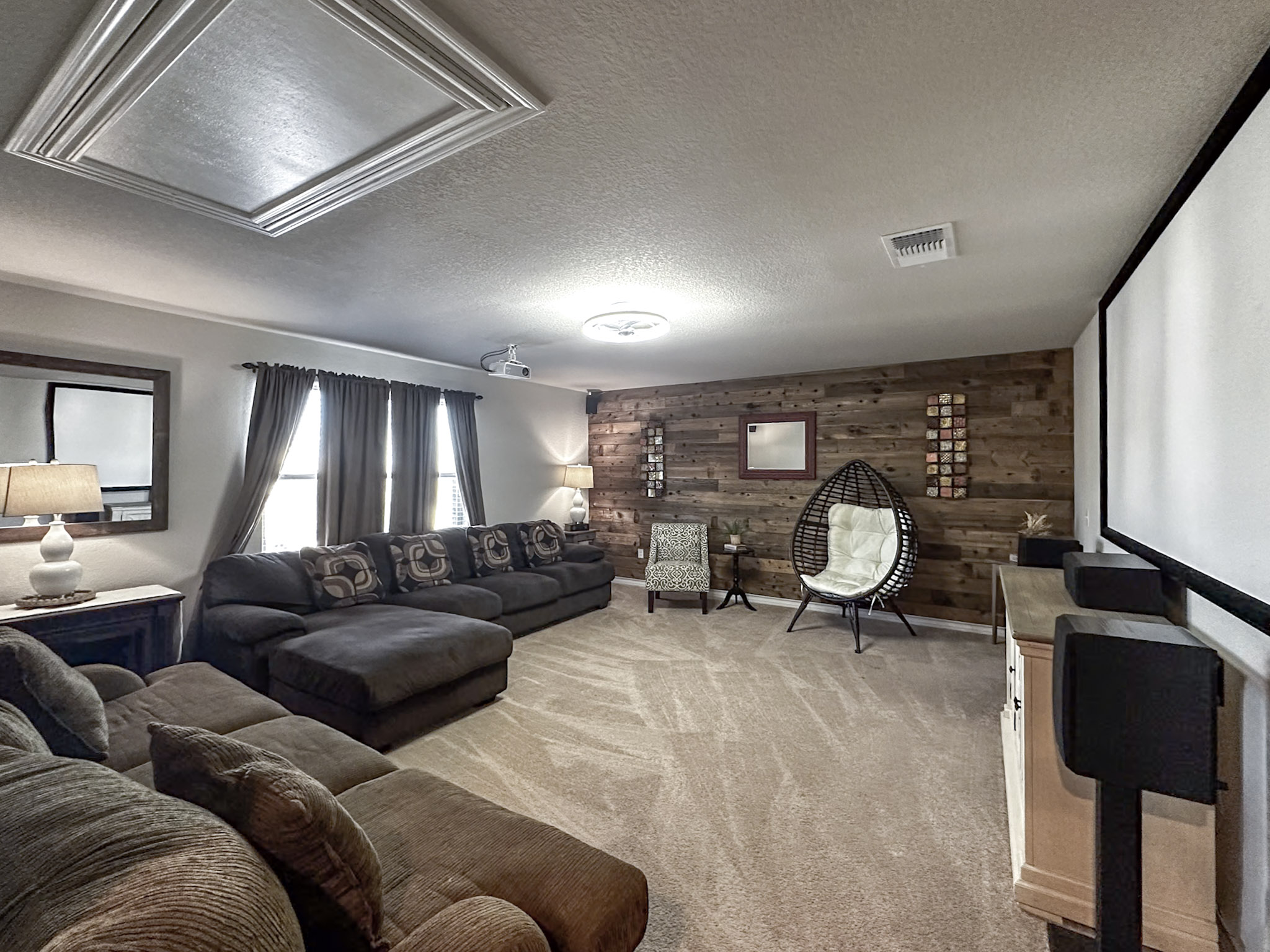 11005 Players Path Austin, TX 78747 - Photo 11 of 40 Home theater featuring wood walls, a textured ceiling, and light colored carpet