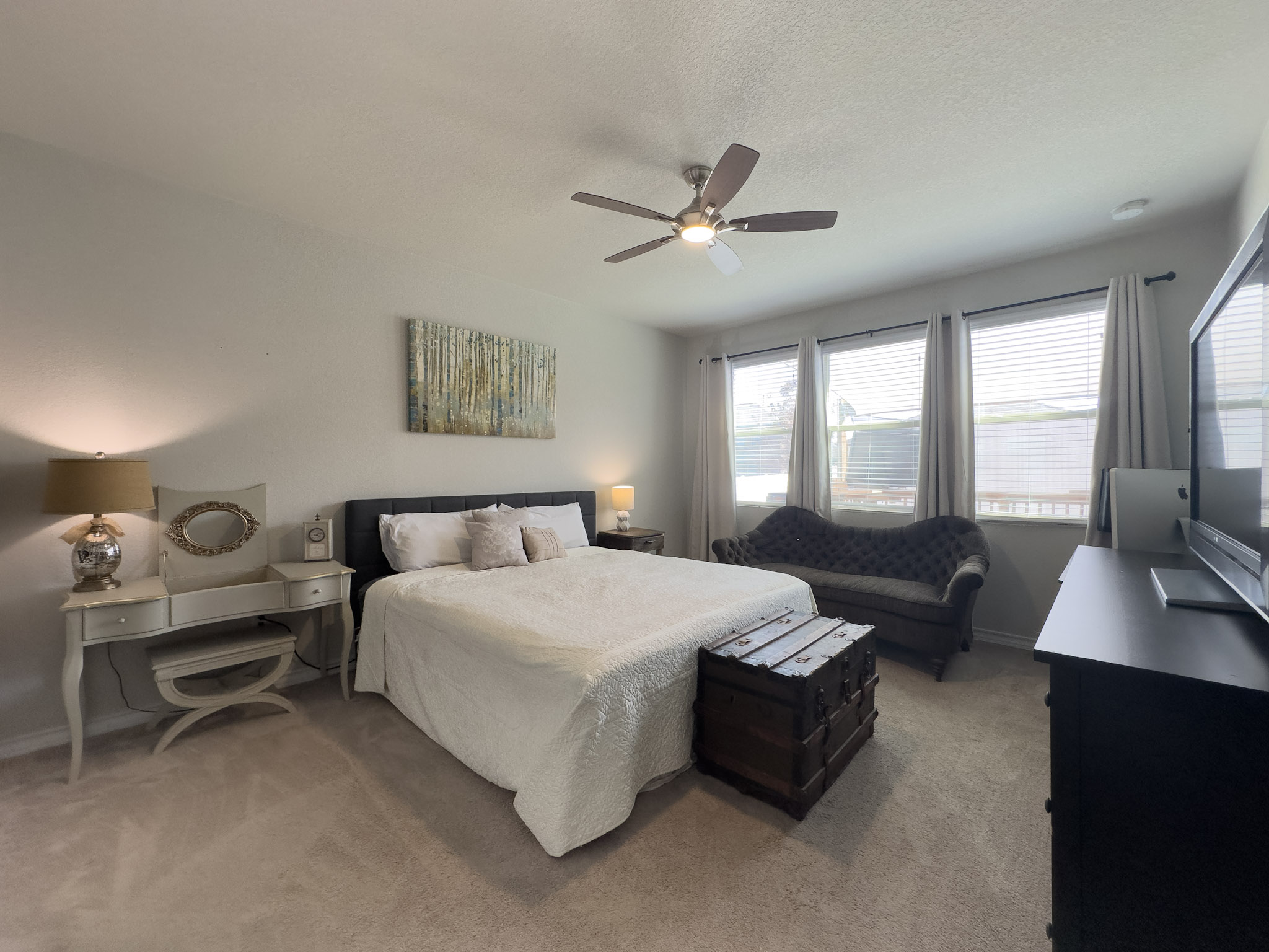 11005 Players Path Austin, TX 78747 - Photo 14 of 40 Bedroom with light colored carpet, ceiling fan, and a textured ceiling