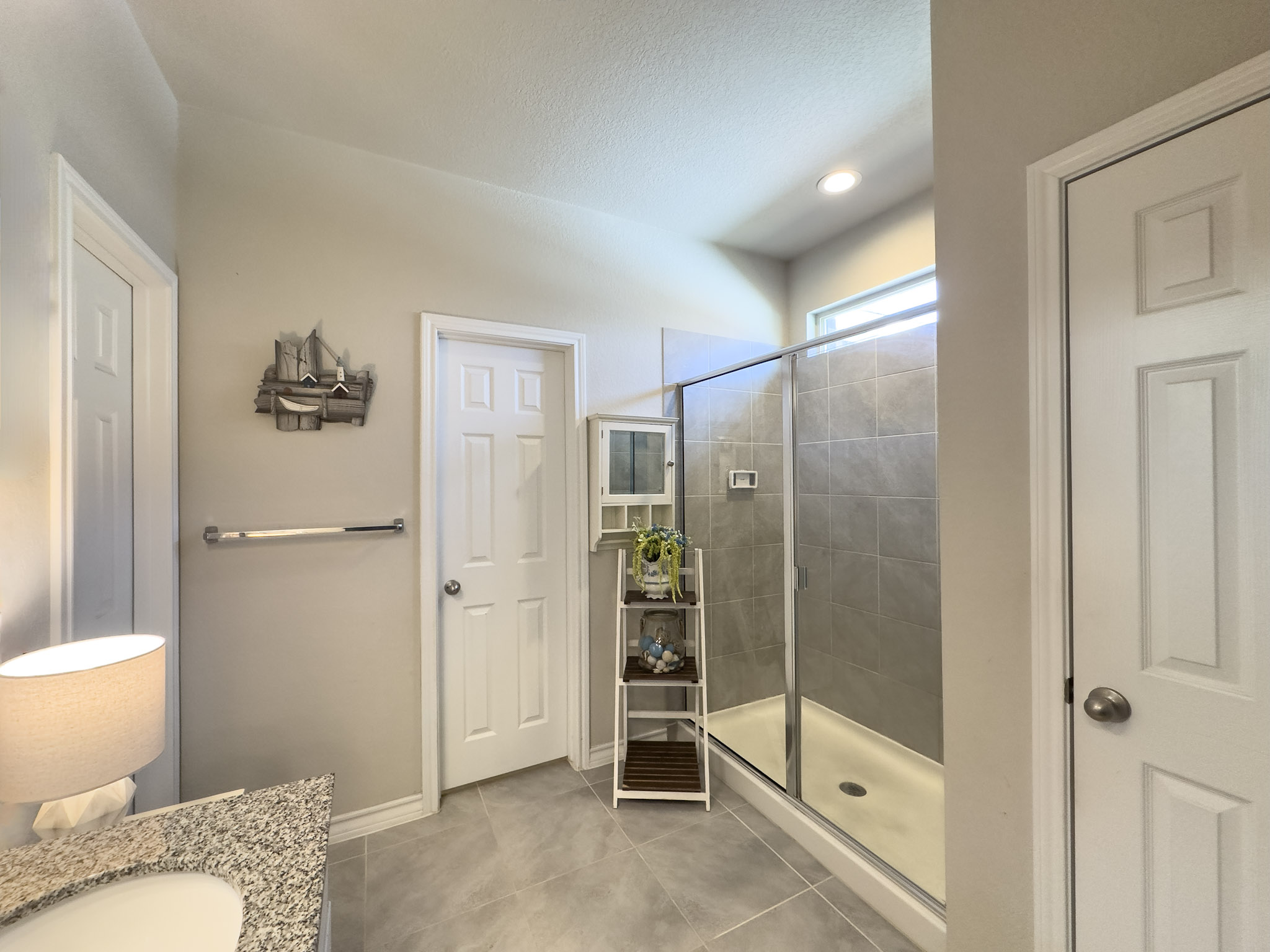 11005 Players Path Austin, TX 78747 - Photo 17 of 40 Bathroom with a shower stall, vanity, light tile patterned floors, a textured ceiling, and recessed lighting