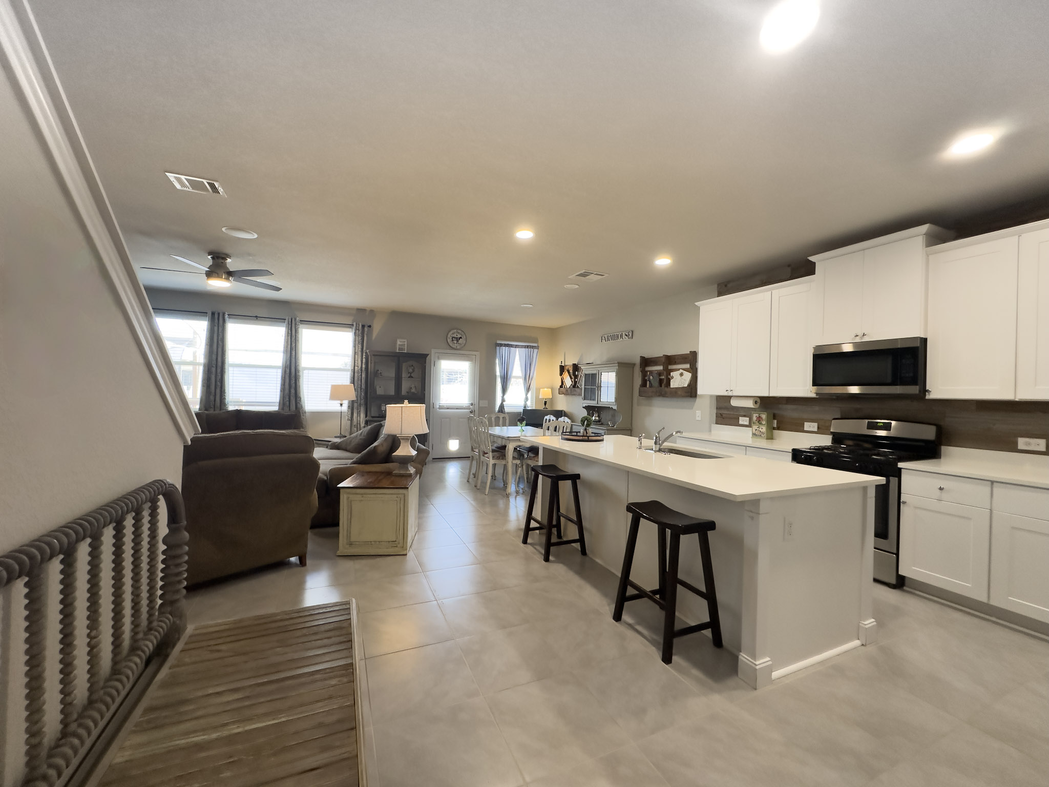 11005 Players Path Austin, TX 78747 - Photo 40 of 40 Kitchen featuring open floor plan, stainless steel appliances, a center island with sink, a kitchen breakfast bar, and white cabinets