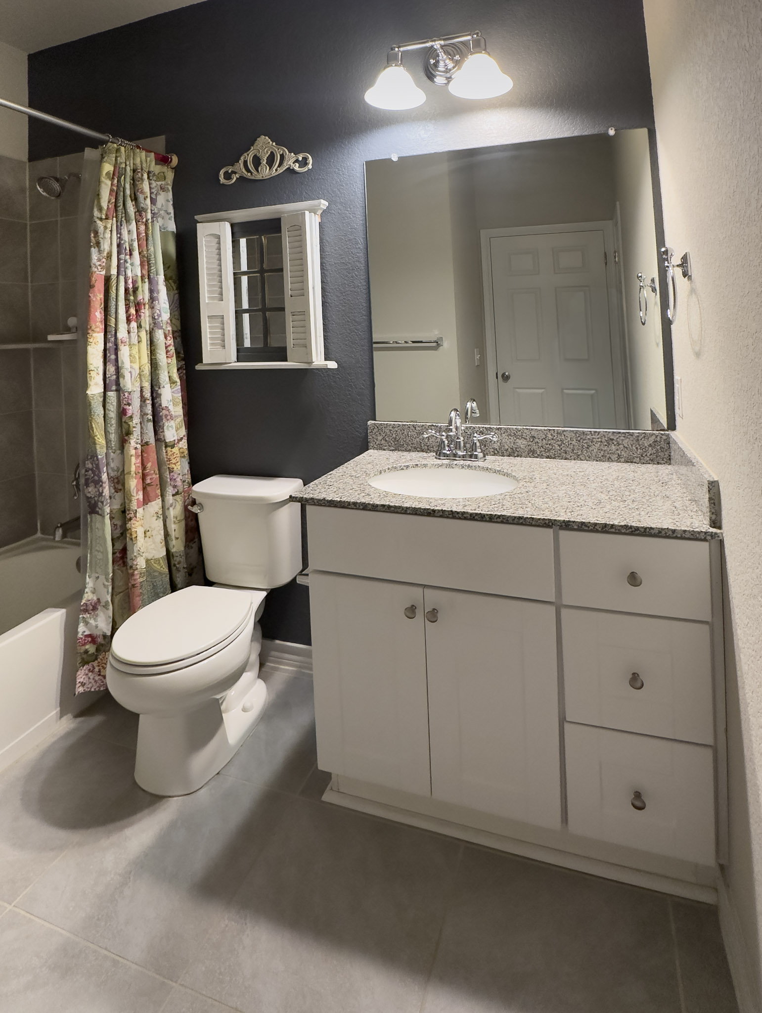 11005 Players Path Austin, TX 78747 - Photo 20 of 40 Full bath featuring a textured wall, shower / bathtub combination with curtain, and vanity