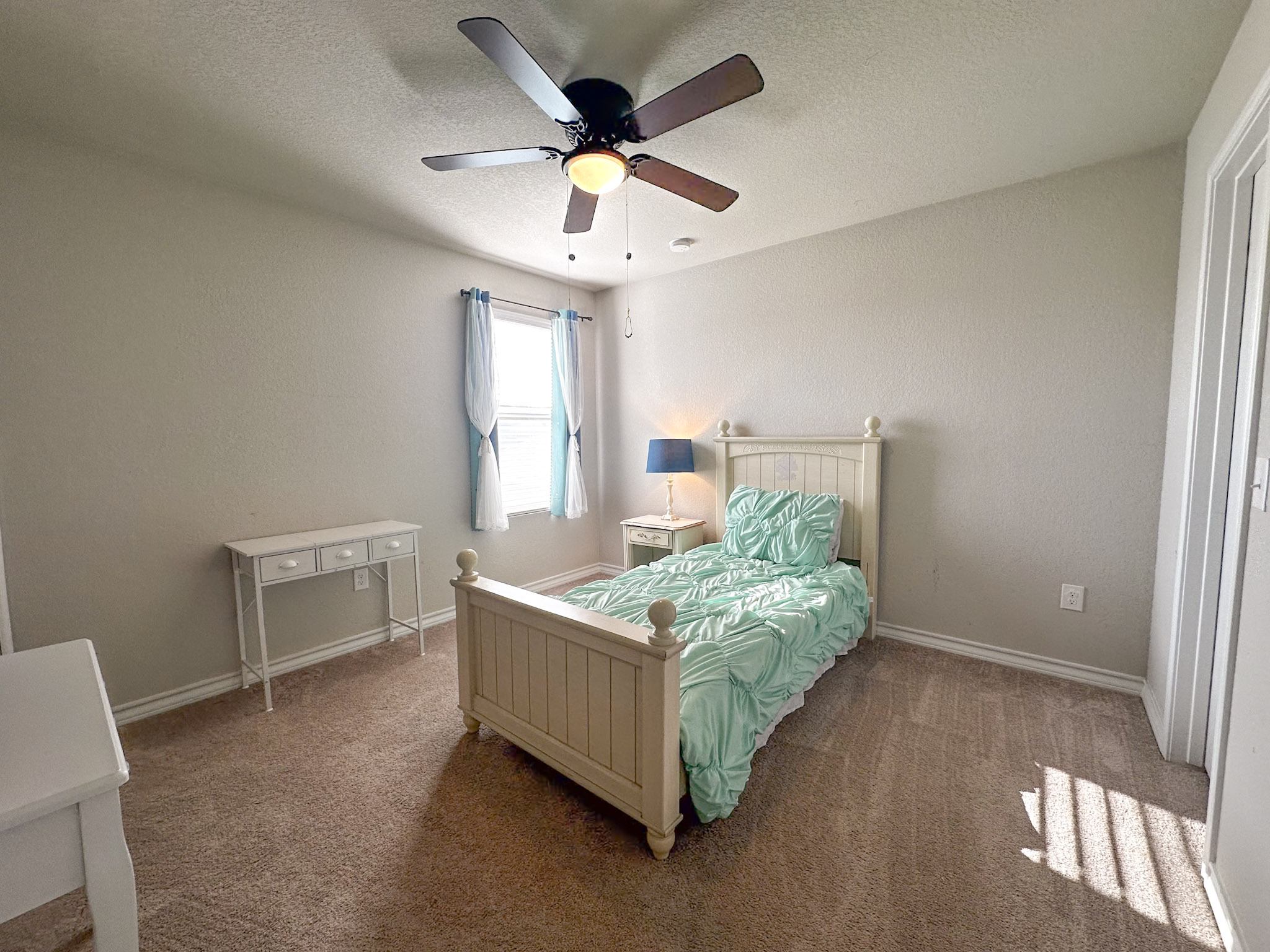 11005 Players Path Austin, TX 78747 - Photo 23 of 40 Bedroom with ceiling fan, a textured ceiling, and carpet