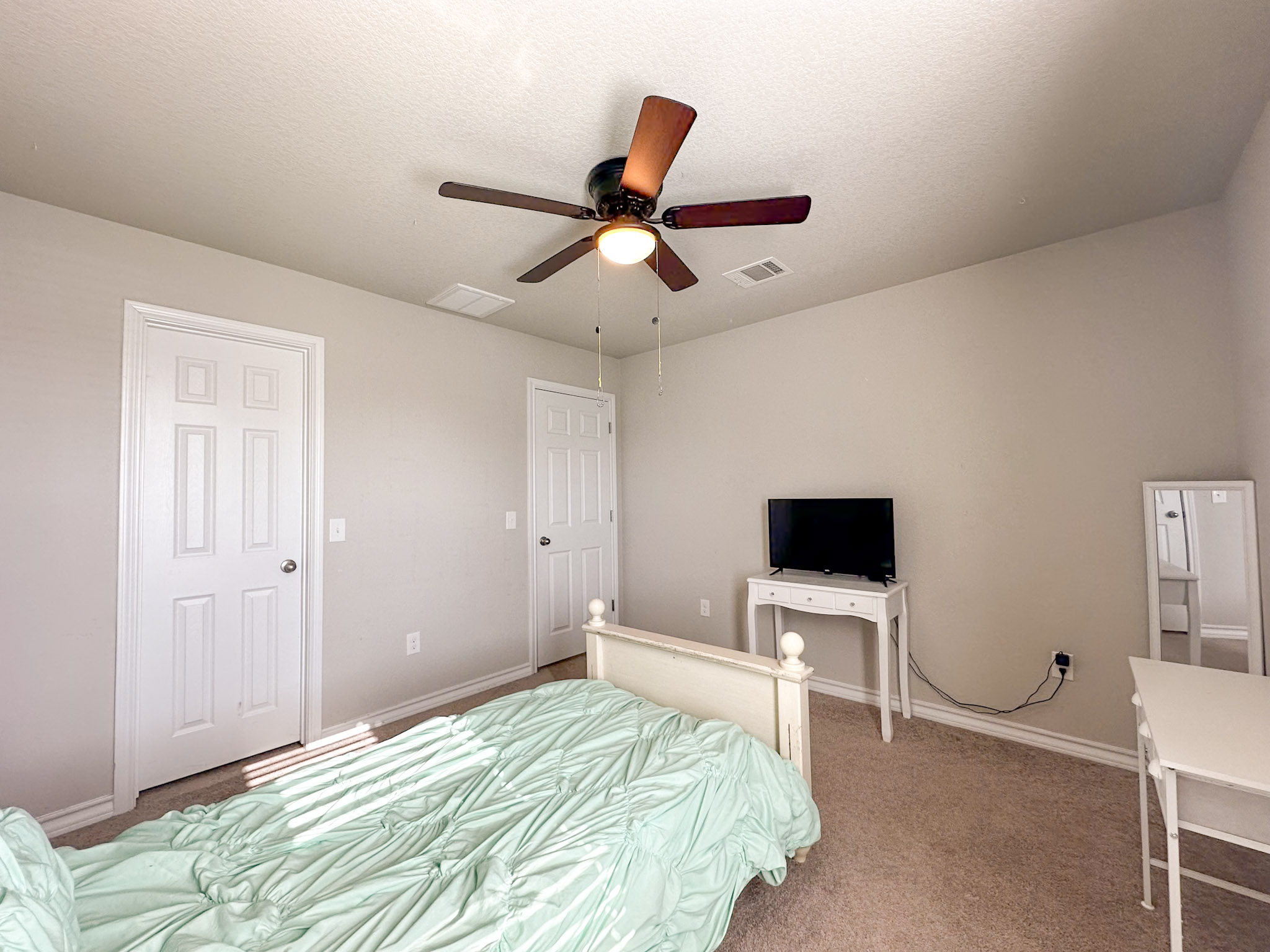 11005 Players Path Austin, TX 78747 - Photo 25 of 40 Carpeted bedroom with a ceiling fan and a textured ceiling