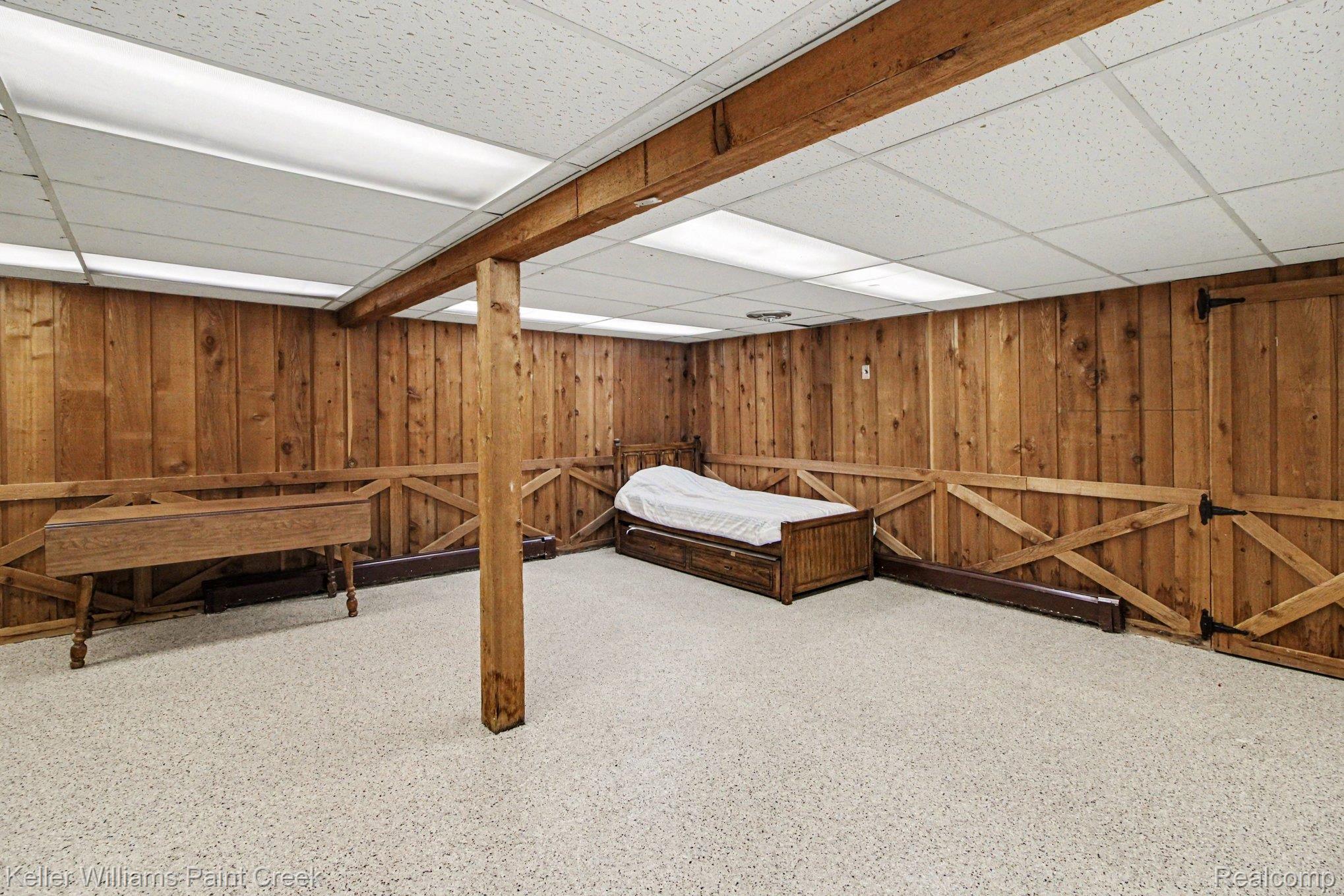 3370 Aquinas Drive Rochester, MI 48309 - Photo 12 of 25 Bedroom featuring a paneled ceiling and wood walls