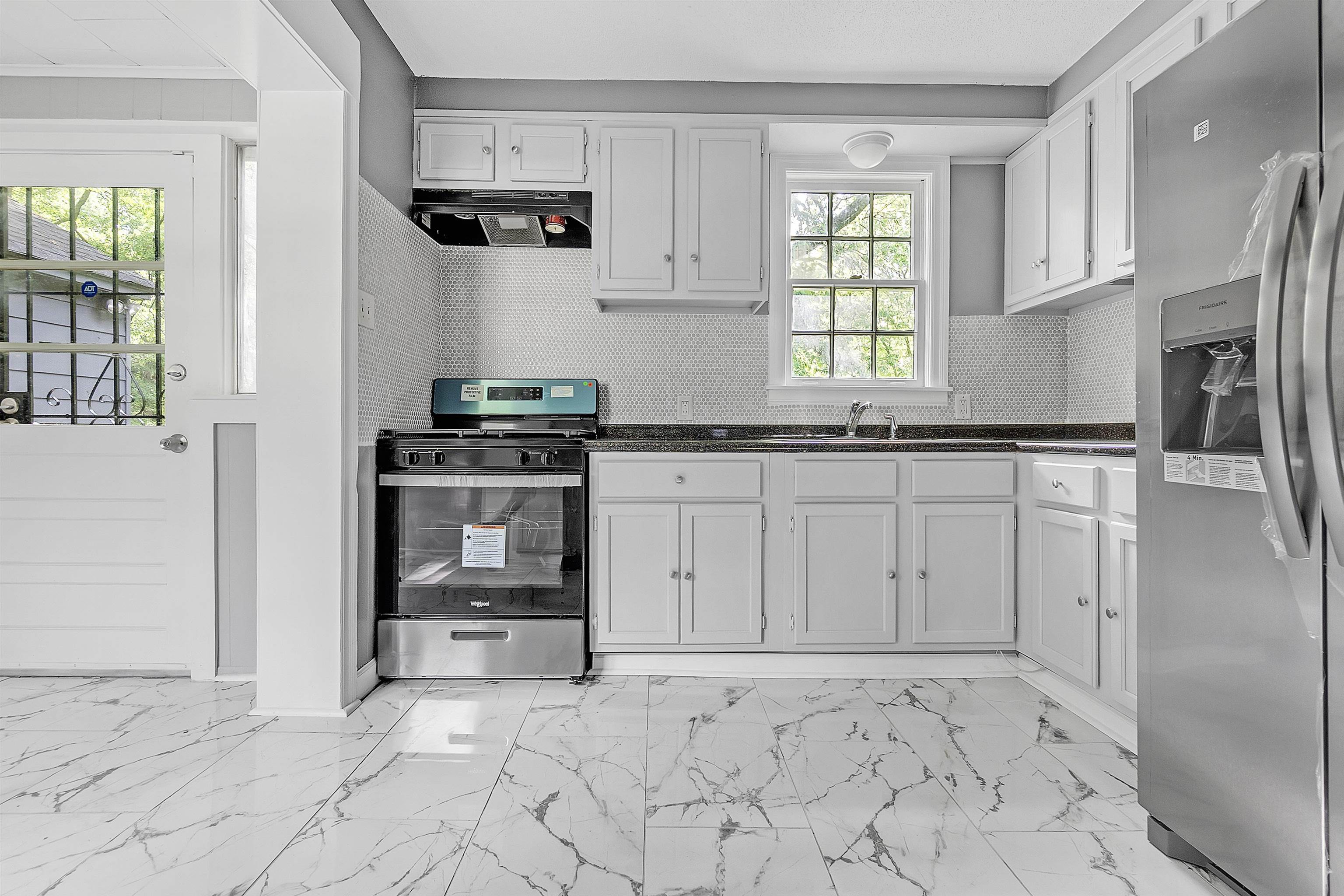 3321 Lakeview Road Memphis, TN 38116 - Photo 11 of 30 a kitchen with white cabinets and appliances