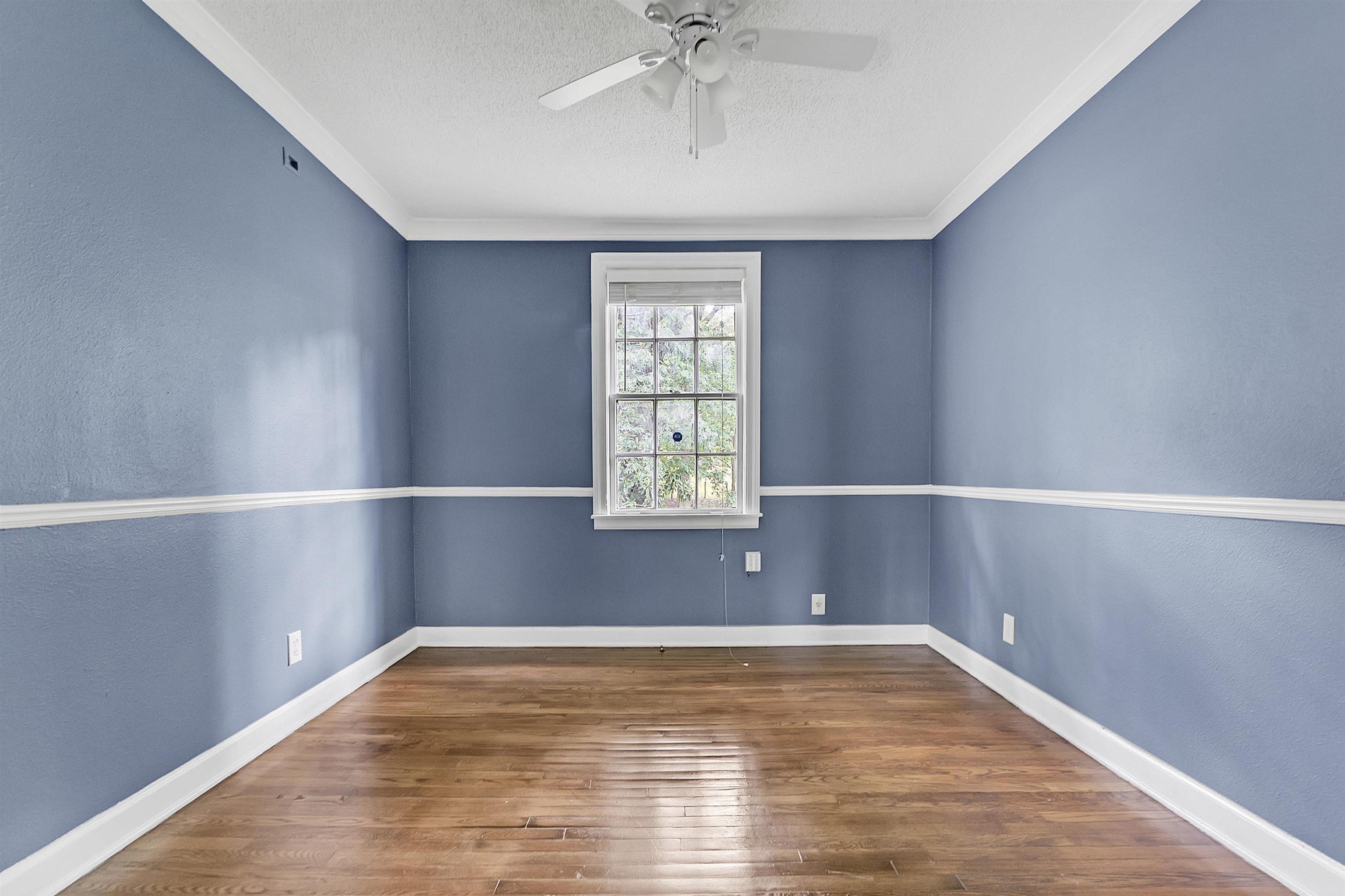 3321 Lakeview Road Memphis, TN 38116 - Photo 7 of 30 a view of empty room with wooden floor and fan