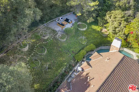 an aerial view of a house with a yard basket ball court and outdoor seating