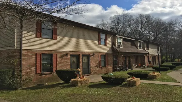 a front view of a house with garden and patio