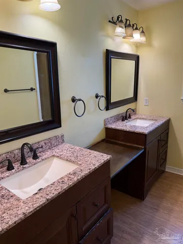 a bathroom with a sink double vanity and a mirror
