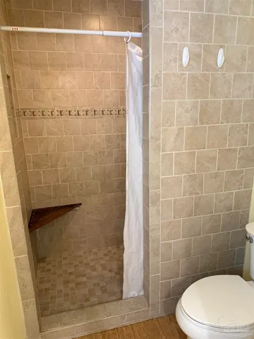 a bathroom with a toilet and shower