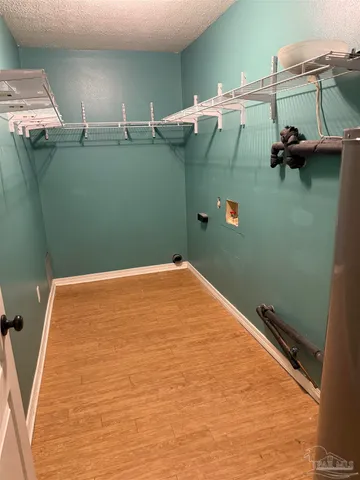 a bathroom with a shower and a wooden floor