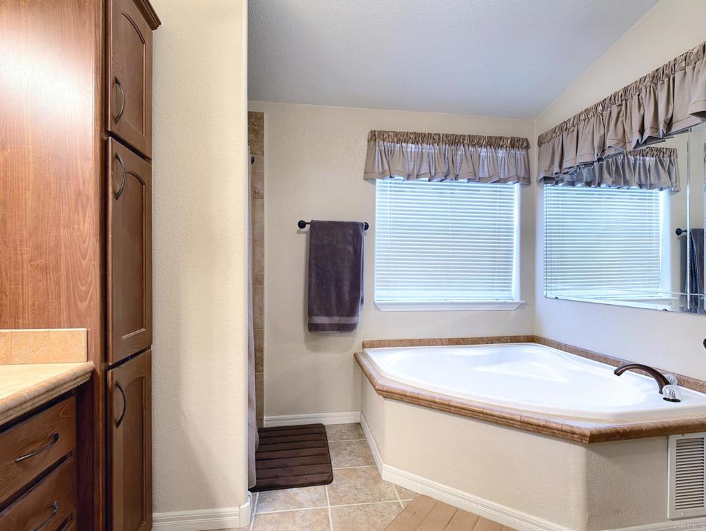 9395 Harritt Road, Unit 215 Lakeside, CA 92040 - Photo 18 of 27 a bathroom with a tub and shower