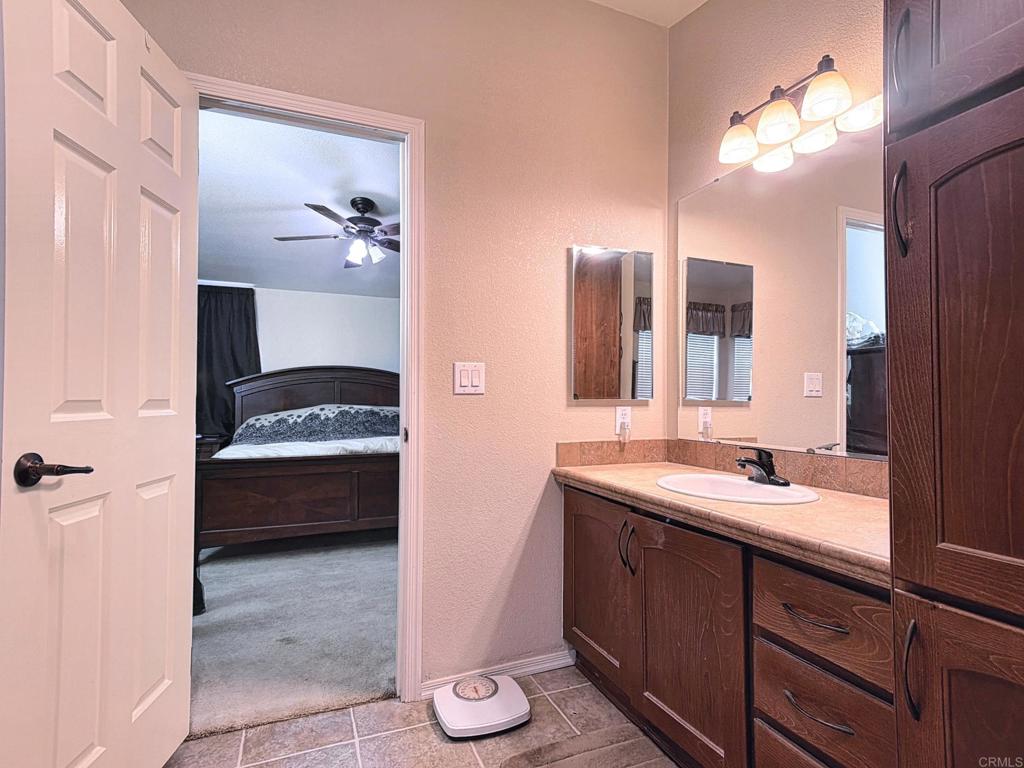 9395 Harritt Road, Unit 215 Lakeside, CA 92040 - Photo 20 of 27 a en suite bathroom with a sink and a mirror