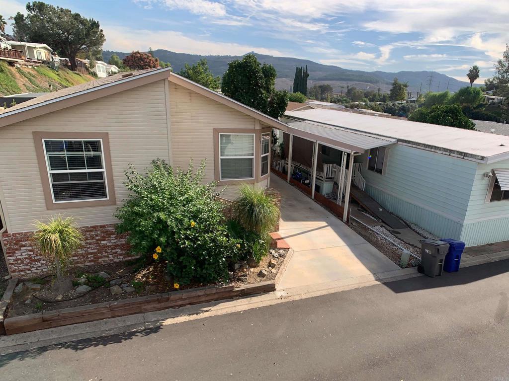 9395 Harritt Road, Unit 215 Lakeside, CA 92040 - Photo 2 of 27 a house with trees in the background