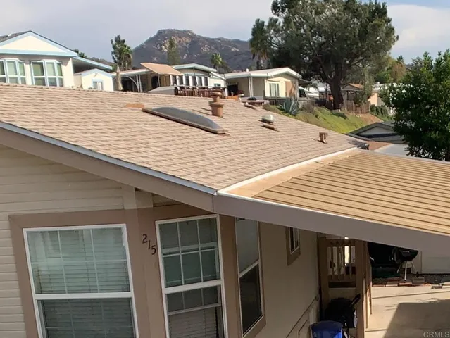 a terrace of a house with wooden floor and fence