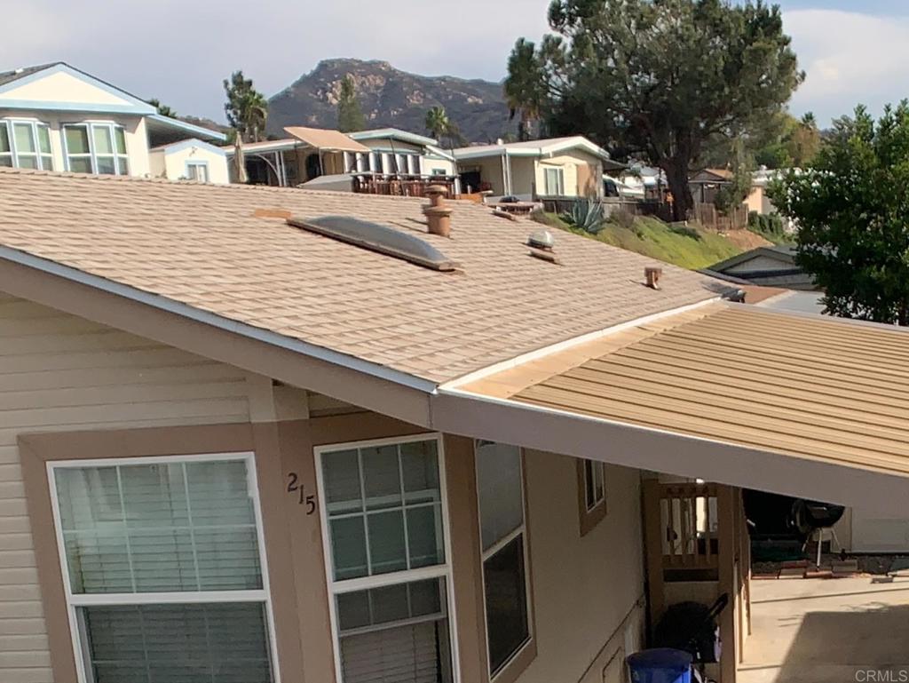 9395 Harritt Road, Unit 215 Lakeside, CA 92040 - Photo 3 of 27 a terrace of a house with wooden floor and fence