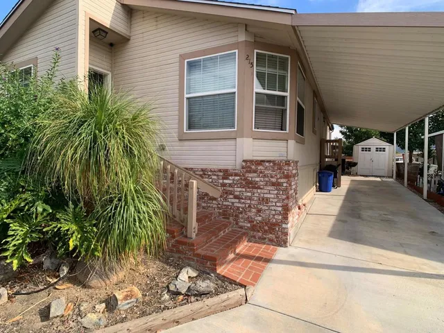 a view of a brick house with plants