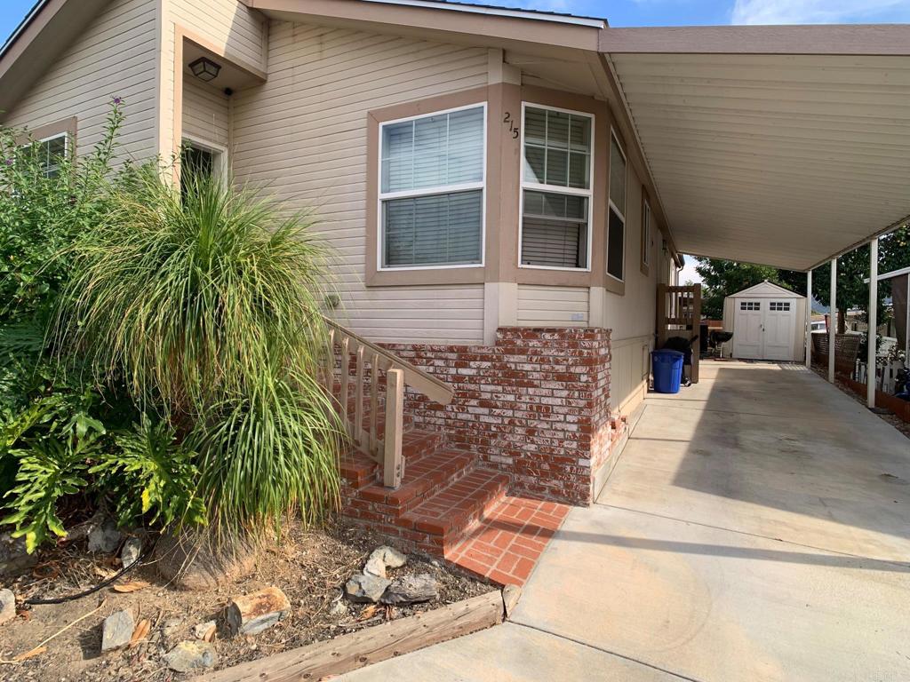 9395 Harritt Road, Unit 215 Lakeside, CA 92040 - Photo 6 of 27 a view of a brick house with plants