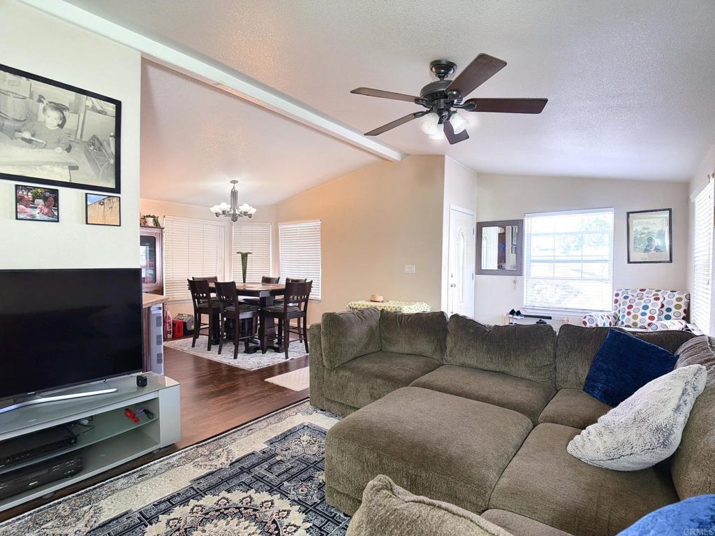 9395 Harritt Road, Unit 215 Lakeside, CA 92040 - Photo 7 of 27 a living room with furniture and a flat screen tv with a chandelier