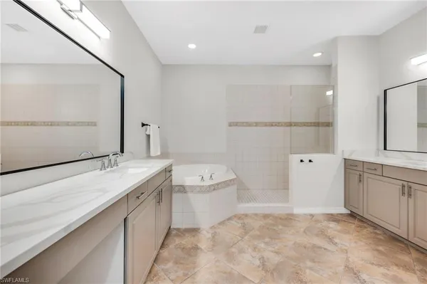 a bathroom with a granite countertop sink a toilet and bathtub