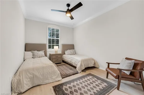 a bedroom with a bed and chair