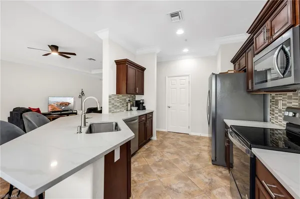 a kitchen with refrigerator and cabinets