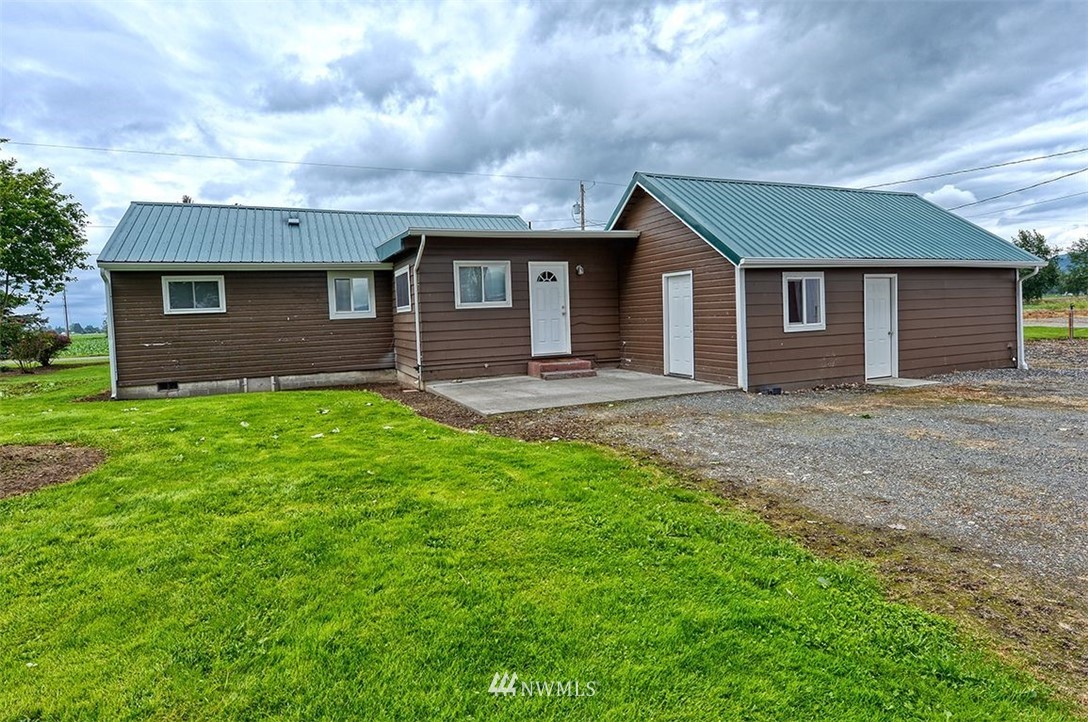 2909 Massey Road Everson, WA 98247 - Photo 7 of 27 a brick house next to a yard with large trees