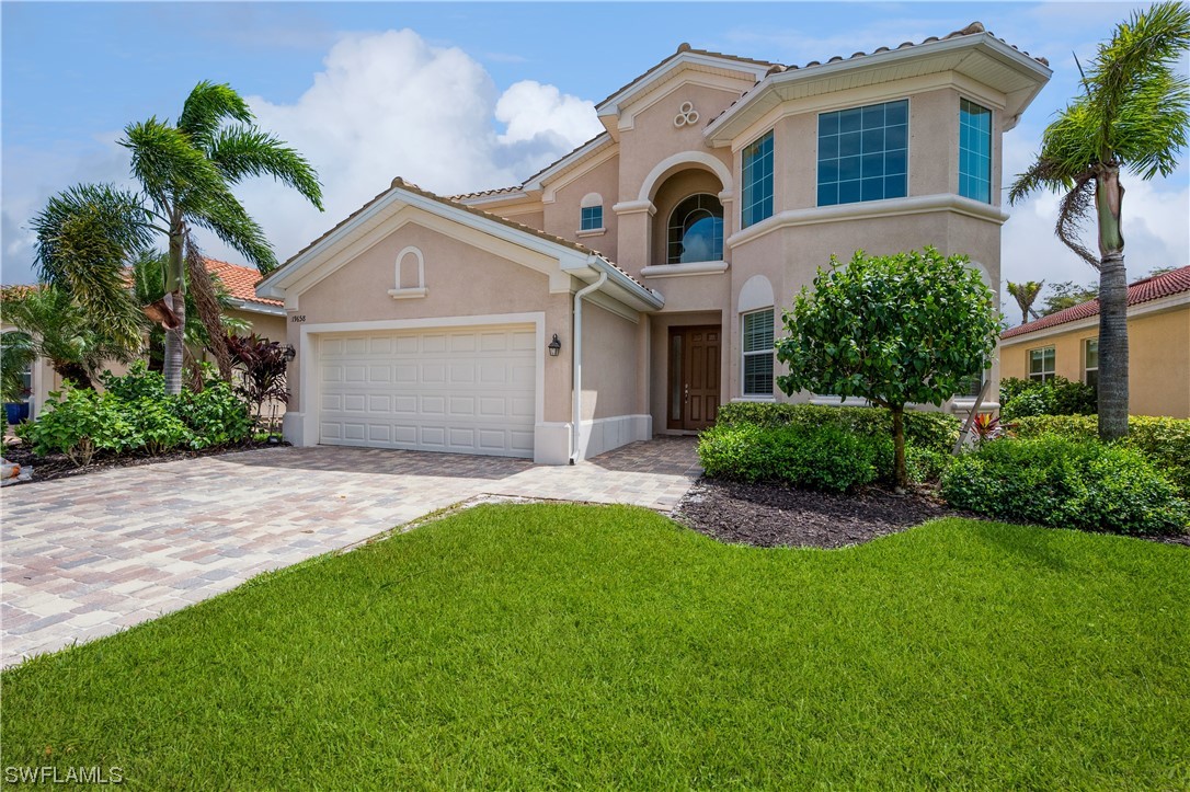 a front view of a house with a garden and plants