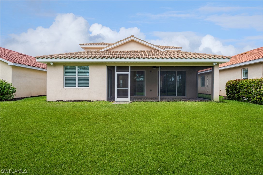 19658 Tesoro Way Estero, FL 33967 - Photo 25 of 25 front view of a house with a garden