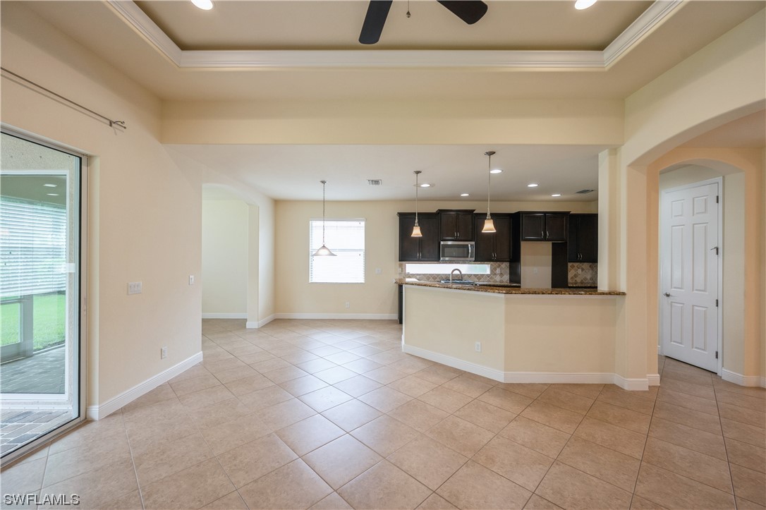 19658 Tesoro Way Estero, FL 33967 - Photo 8 of 25 a view of kitchen with kitchen island stainless steel appliances wooden floor and window