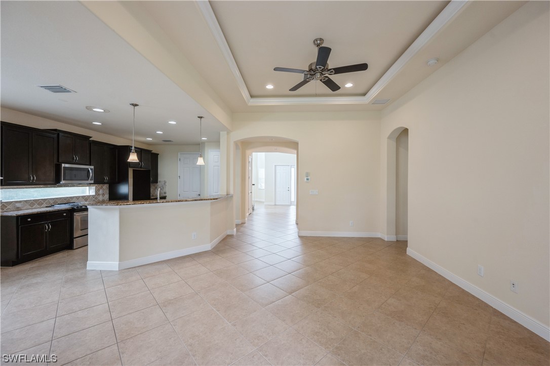 19658 Tesoro Way Estero, FL 33967 - Photo 9 of 25 a view of a kitchen with a sink stainless steel appliances and cabinets