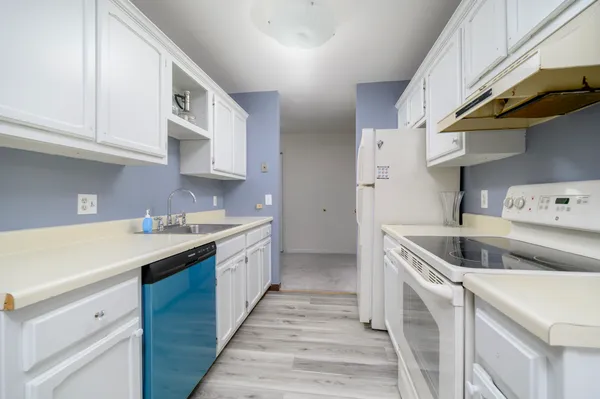 a kitchen with a sink a stove and cabinets