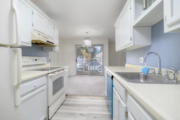 a kitchen with stainless steel appliances granite countertop a sink stove and cabinets