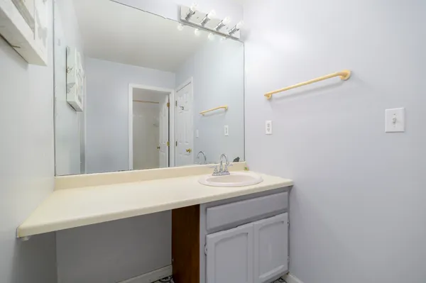 a bathroom with a sink a mirror and a vanity